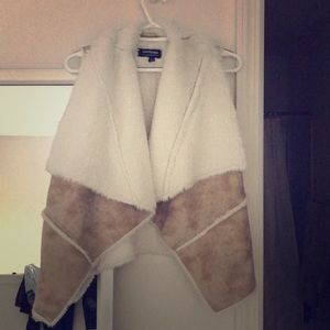 Fur jacket with leather like outside. No sleeves.